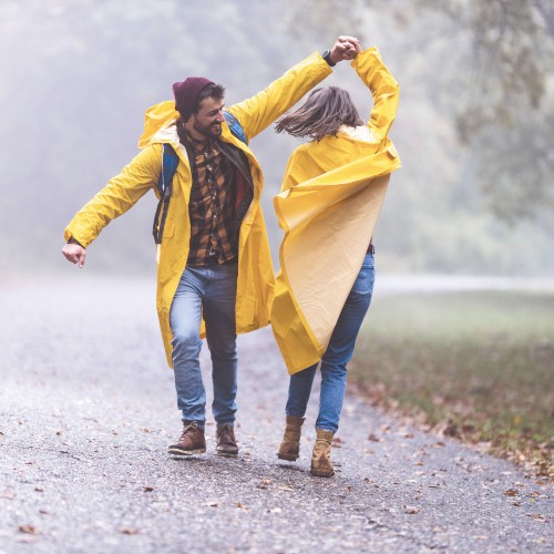 Man and woman dancing in the rain